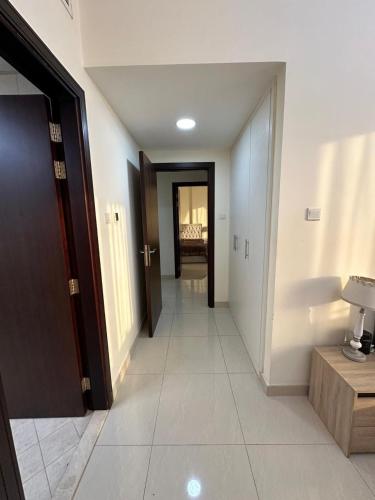 a hallway with a hallway leading to a room at Big flat 3 bedrooms, in floor 15 full service in Sharjah