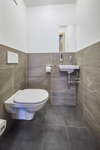 a bathroom with a toilet and a sink at AlpenParks Hotel & Apartment Sonnleiten in Saalbach Hinterglemm