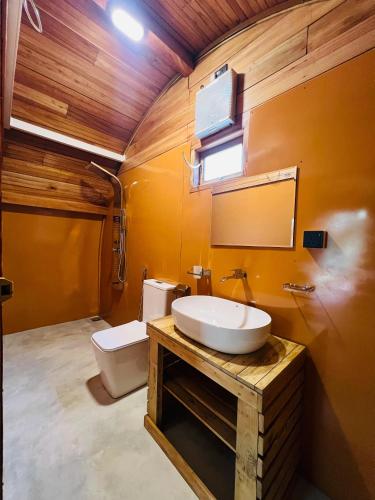 a bathroom with a sink and a toilet at Garden Oasis Rekawa in Rekawa