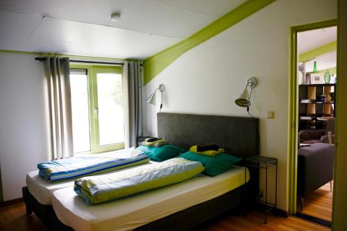 a bedroom with a bed with two pillows on it at De schaapskooi op prachtig landgoed in Gaast