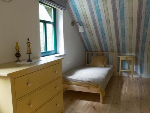 a small bedroom with a bed and a window at Willa Gruszki Puszcza Białowieska 