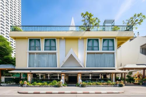 a yellow building with a large triangle on top of it at Royal Ivory Sukhumvit Nana in Bangkok