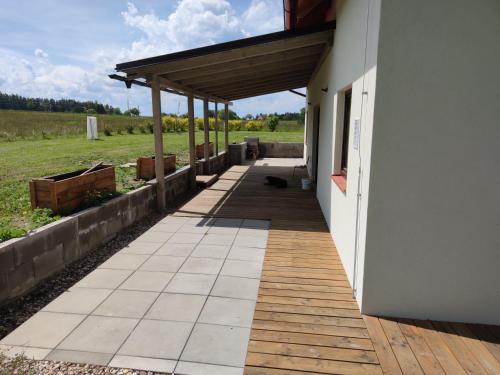 a porch of a house with a cat laying on the sidewalk at Chalupa Seč in Seč