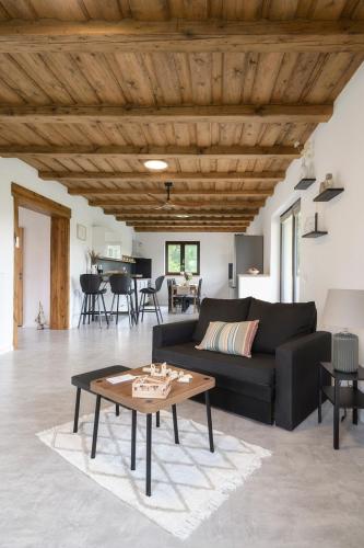 a living room with a black couch and a table at Chalupa Seč in Seč