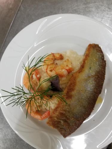 a plate of food with shrimp and a piece of bread at Hotel-Restaurant Fischerwirt in Gratwein