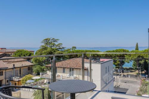 a balcony with a table and a view of a city at Hotel San Marco in Bardolino