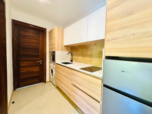 a kitchen with a refrigerator and a sink at Beach cozy Studio in Bain Boeuf