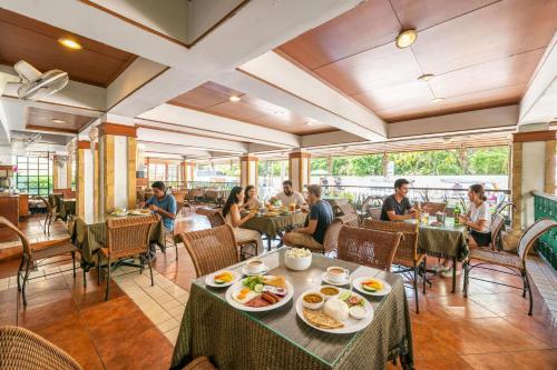 a group of people sitting in a restaurant at Royal Ivory Sukhumvit Nana in Bangkok