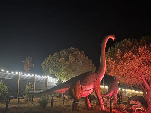 a statue of a dinosaur at night at Casa Pito in Santo António do Baldio