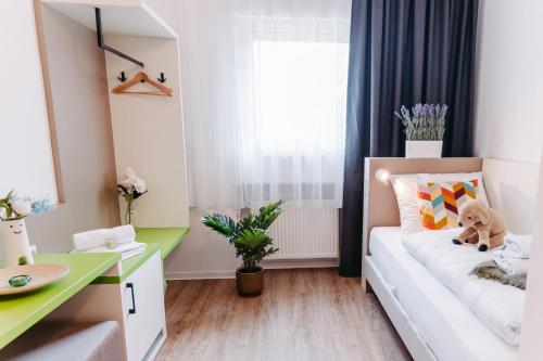 a small room with a white couch and a desk at bestprice Hotel Koblenz in Koblenz