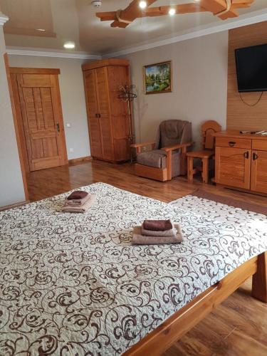 a bedroom with a large bed with a rug on it at Dayarta in Skhidnitsa