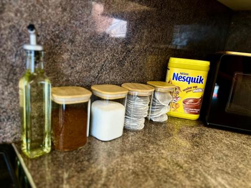 a group of jars and a bottle of essential oils on a counter at Free Parking 11 Guests Family&Contractors Bedford in Bedford