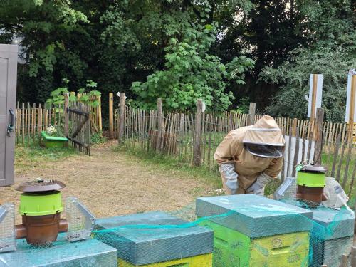 a man bending over in front of a fence at Le 46 Appart Hotel Entre Paris Disneyland Parc Asterix Navette in Villiers-sur-Marne