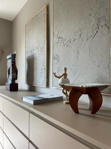 a living room with a table and a wall at Stylish * Sunny * Cosy House in Heemstede