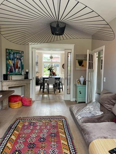 a living room with a couch and a table at Stylish * Sunny * Cosy House in Heemstede