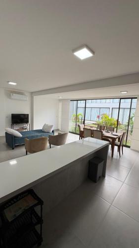 a large living room with a couch and a table at Reserva Ponta do Mutá 07 in Barra Grande