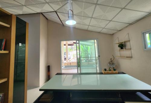 an empty room with a table and a window at HOMEis Villa Sattahip in Ban Tao Than