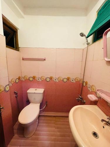 a bathroom with a toilet and a sink at THE LaZORI GRAND VILLA in Nuwara Eliya
