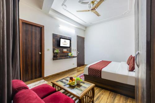 a hotel room with a bed and a couch at Hotel Airport Sinon in New Delhi