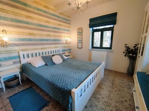a bedroom with a large bed in a room at Willa Gruszki Puszcza Białowieska 