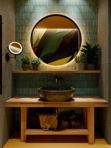 a bathroom with a bowl on a counter with a mirror at Stara Pravda Hotel - Vykrutasy in Bukovel