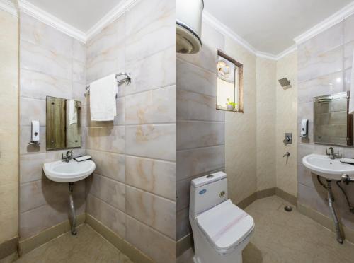 a bathroom with a toilet and two sinks at Hotel Airport Sinon in New Delhi