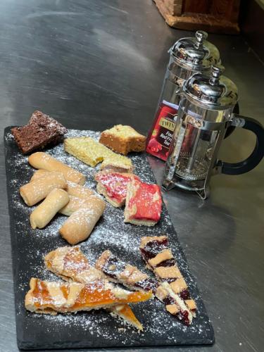 a tray of different types of food on a table at Agriturismo Casale Montebello in Monteleone di Spoleto