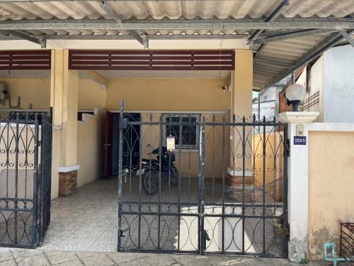 a gate to a building with a bike parked inside at Kbk home in Yala