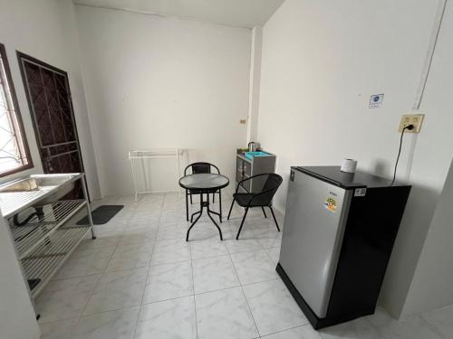 a room with a small table and a small refrigerator at Kbk home in Yala