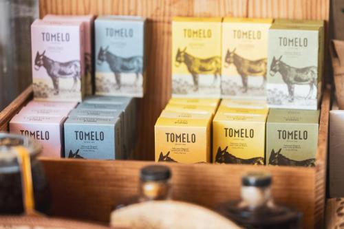 a shelf filled with boxes of horse poop at Hotel Rural Sra De Pereiras in Vimioso