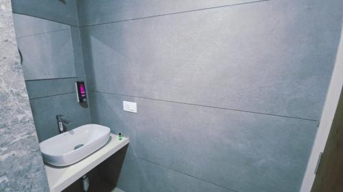 a bathroom with a sink and a toilet in it at Hotel Laxmi Elite Karad in Karad