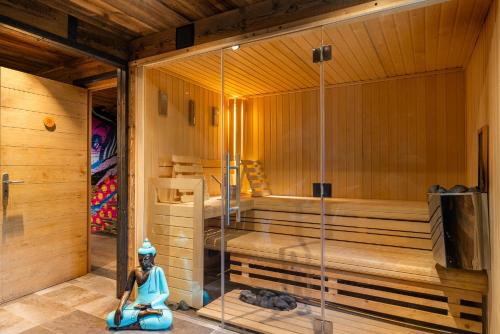a sauna with a statue of a woman sitting in a room at Black Diamond - Tignes in Les Brévières