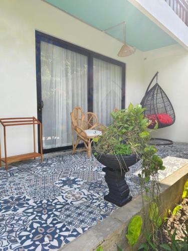 a living room with a blue and white tile floor at Casa Nemo Beach Resort & Spa in Sabong