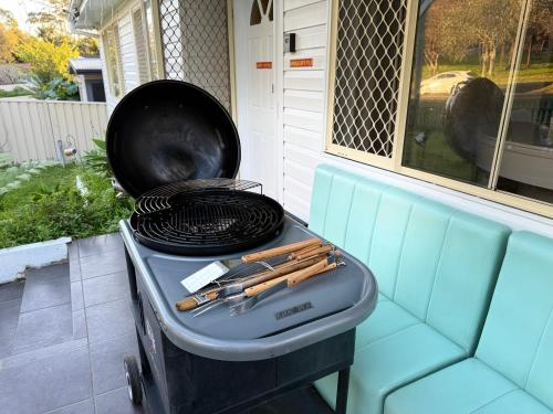 a grill with a pan on top of it at Fairyland Getaway- at Central Coast with XXXL hot Jacuzzi & Fun - Round pool table and Slide bunk bed in Narara