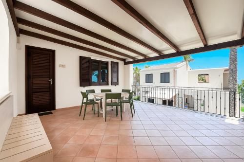 a patio with a table and chairs on a balcony at Resort Santa Maria Hotel in Birgi Vecchi