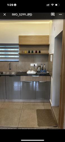 a kitchen with a sink and a counter top at Paradise-Vadanappally Beach Villa for 4-5 adults in Irimbranallūr