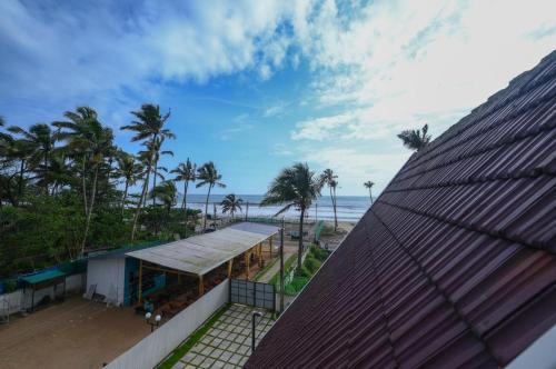 a view of the beach from the roof of a building at Paradise-Vadanappally Beach Villa for 4-5 adults in Irimbranallūr