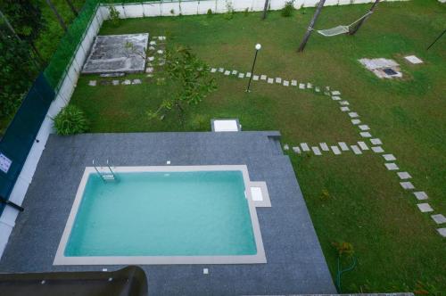 an overhead view of a swimming pool in a yard at Paradise-Vadanappally Beach Villa for 4-5 adults in Irimbranallūr