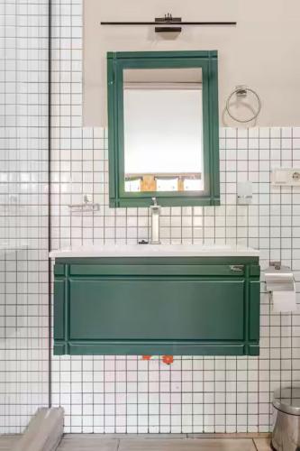 a bathroom with a green sink and a window at Apartment with Fireplace in Old Tbilisi in Tbilisi City