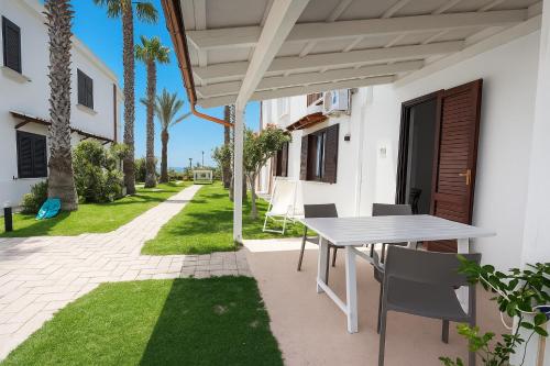 a table and chairs on the patio of a house at Resort Santa Maria Hotel in Birgi Vecchi