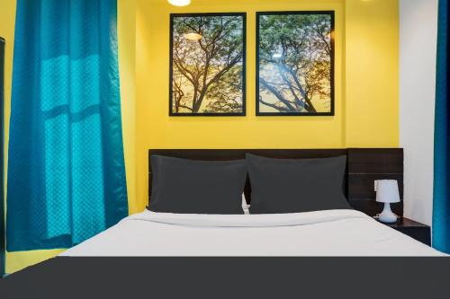 a bedroom with a bed and two windows at Super Aarambh Exotica in Pune