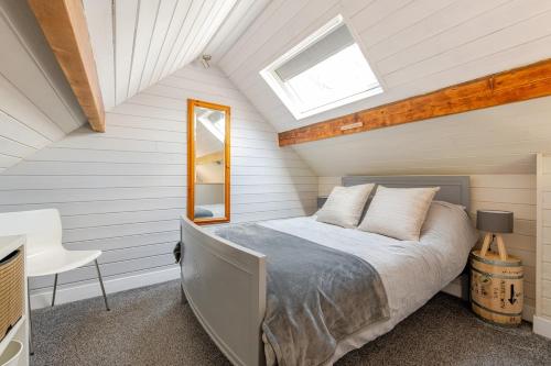 a bedroom with a bed and a skylight at The Scullery - a quirky annex with wood fire in Huddersfield