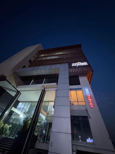 a tall building with a sign on it at night at Nvista Luxe Living in Islamabad