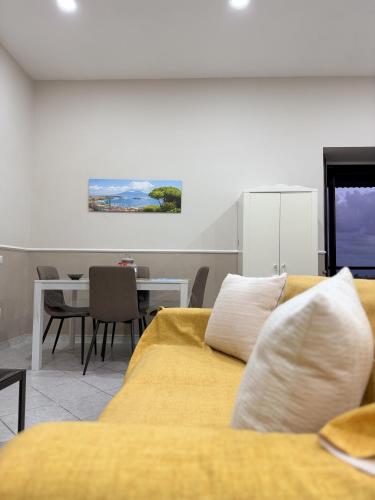 a living room with a couch and a dining table at Casa Vacanza da Rosy in Boscotrecase