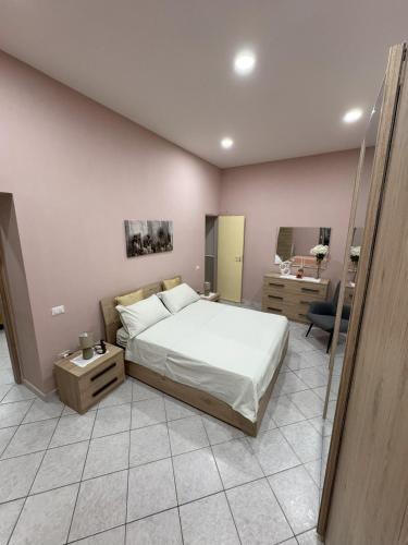 a bedroom with a large bed and a bathroom at Casa Vacanza da Rosy in Boscotrecase