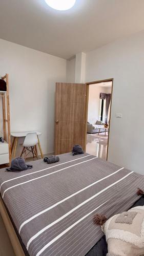 a bedroom with a large bed in a room at White Pearl 2BR Beachfront House Malibu Seaview in Mae Haad