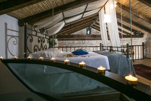 a bedroom with a bed with candles on it at Ktima Karageorgou in Areopolis