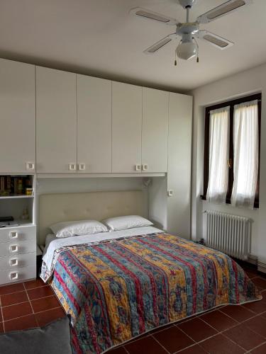 a bedroom with a bed and a ceiling fan at Landscapesilvia 1 Aria in Menaggio