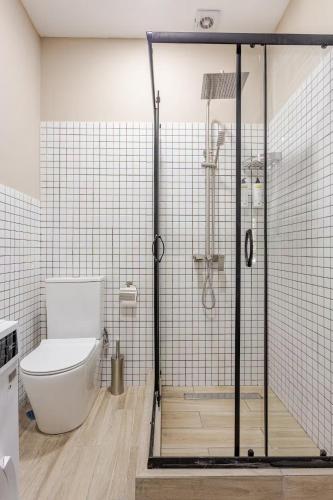a bathroom with a toilet and a glass shower at Tbilisi Rooftop in Tbilisi City