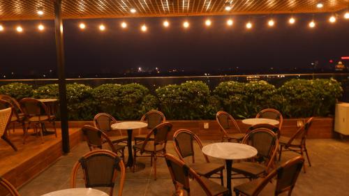 a row of tables and chairs on a balcony at night at MD Hotel in Mỹ Lộc